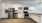 Spacious and well lit kitchen with wood floors and stainless steel appliances